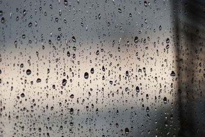 Full frame shot of raindrops on glass window