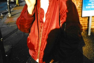 Low section of woman standing in city