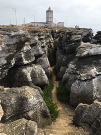 Rock formations by building against sky