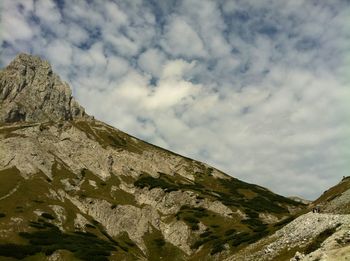 Scenic view of mountains against cloudy sky