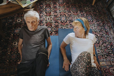 Senior couple doing yoga at home