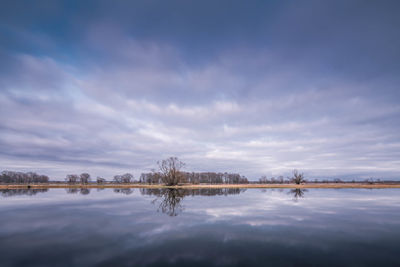 Scenic view of lake against sky during winter