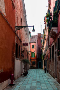 Narrow alley amidst buildings against clear sky