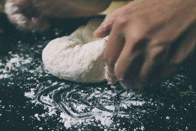 Cropped hand of person preparing food