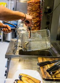 Cropped hand of man preparing food