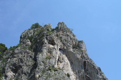 Low angle view of sculpture against clear blue sky