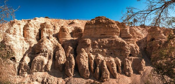 Low angle view of rock formations against sky