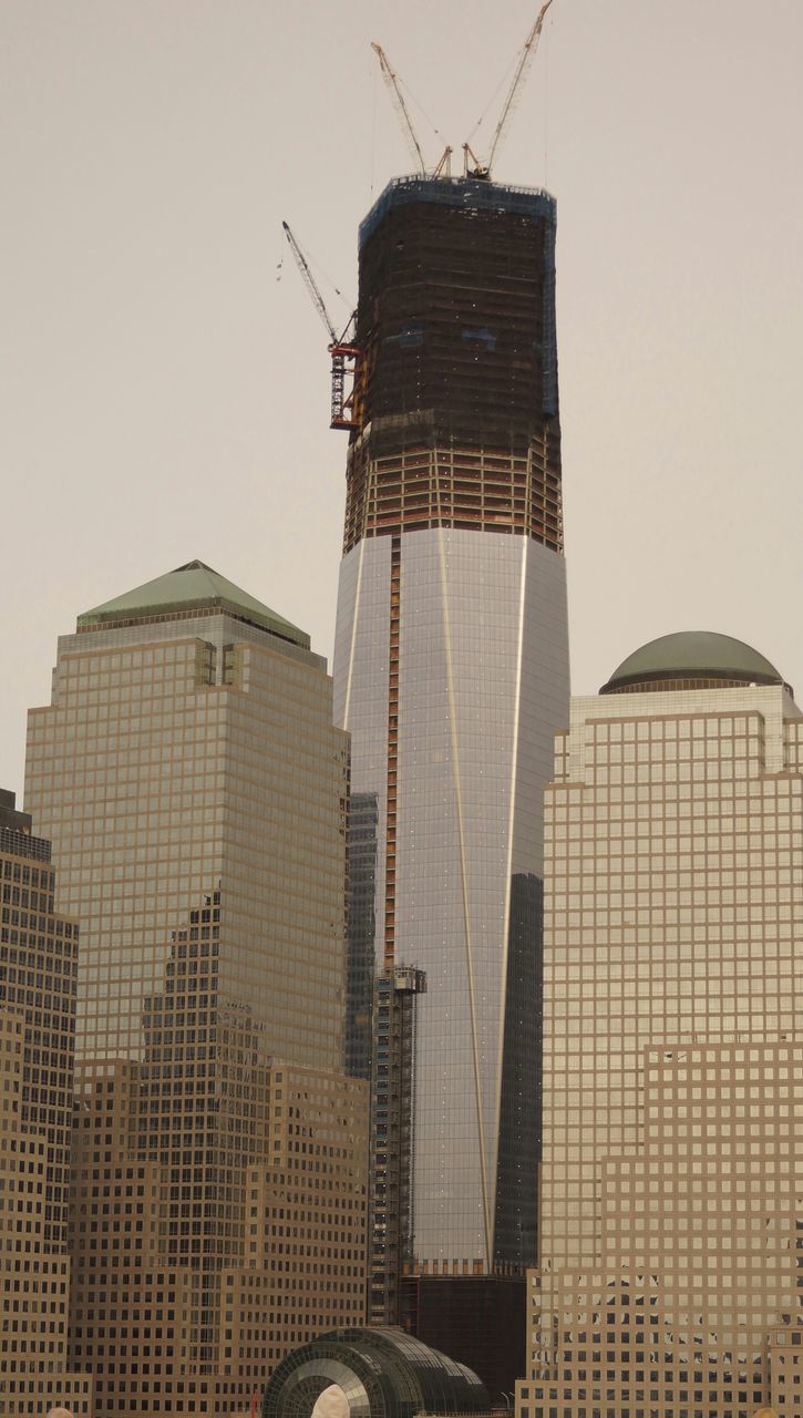 building exterior, architecture, built structure, tall - high, tower, skyscraper, city, low angle view, modern, clear sky, office building, development, construction site, tall, building, sky, capital cities, construction, crane - construction machinery, day