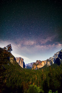 Scenic view of mountains against sky at night