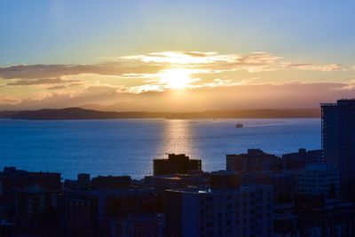Cityscape against sky during sunset