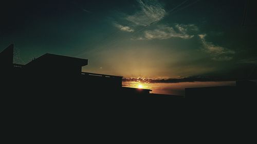 Low angle view of silhouette city against sky during sunset