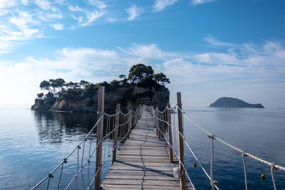 Pier over sea against sky