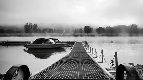 View of jetty in lake against sky