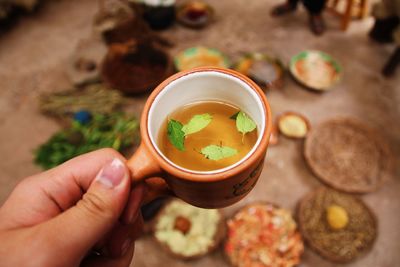 High angle view of hand holding food on table