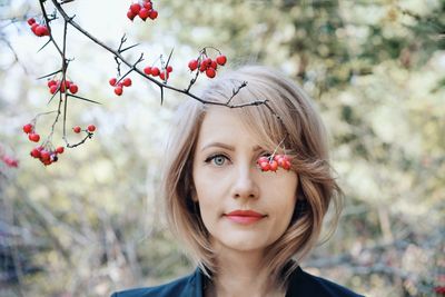 Portrait of beautiful woman by trees