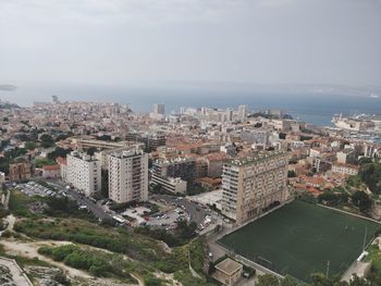 High angle view of buildings in city against sky