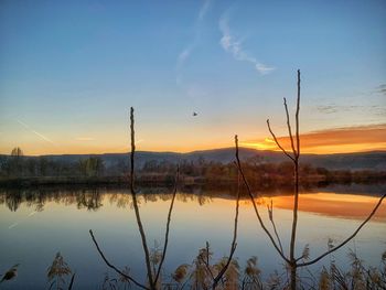 Scenic view of lake against sky during sunset