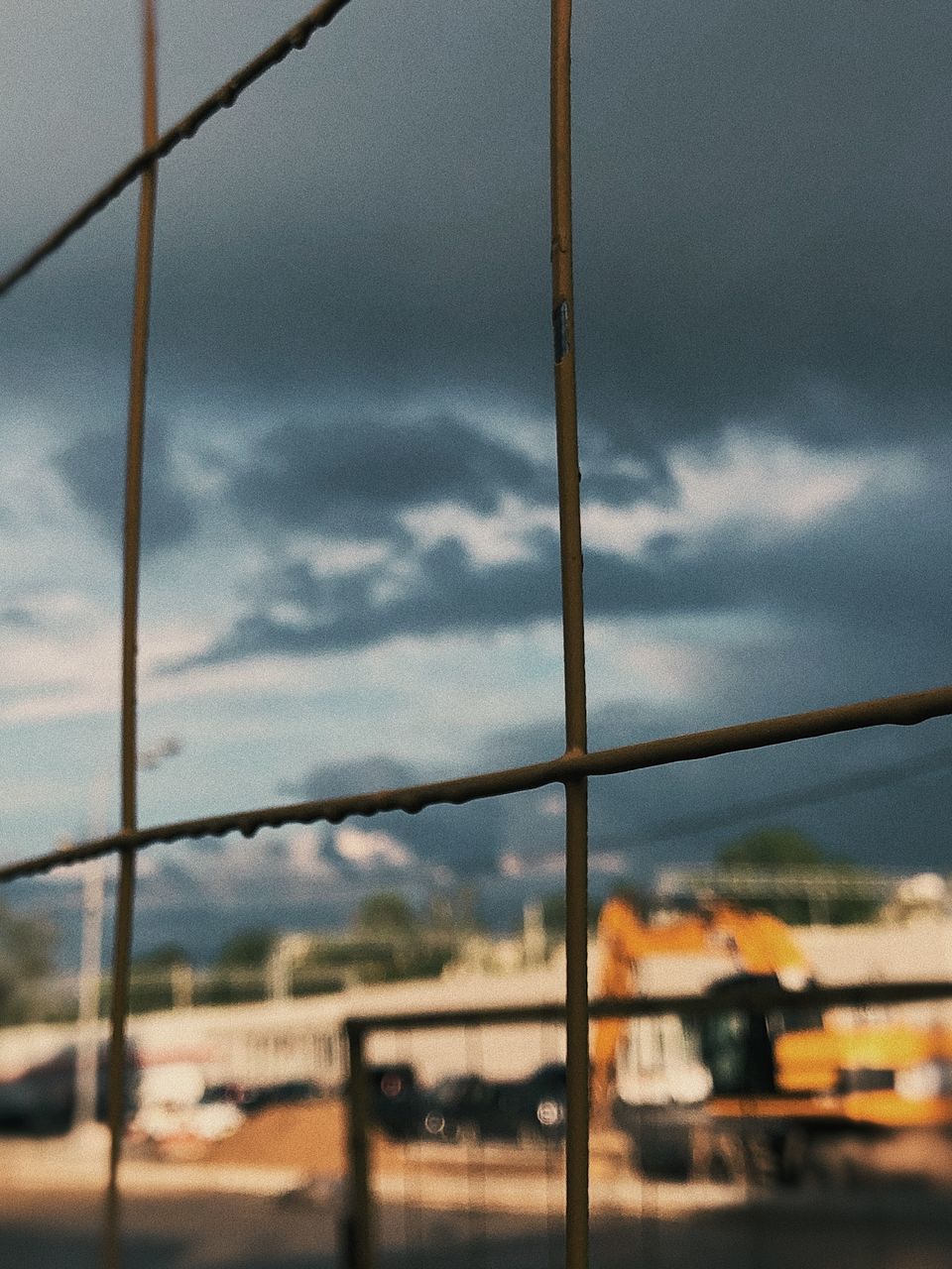 CLOSE-UP OF CAR WINDOW AGAINST SKY