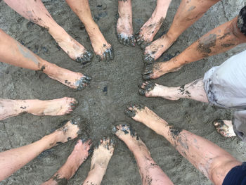 Low section of people standing in mud