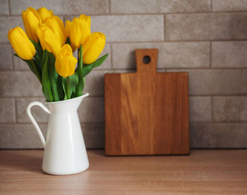Beautiful yellow tulip flowers on table at kitchen
