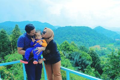 Rear view of couple standing on mountain