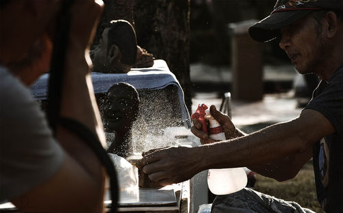 Man spraying on statue outdoors