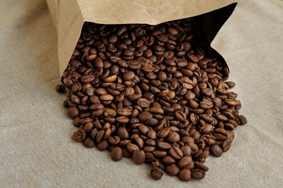 Close-up of roasted coffee beans on table