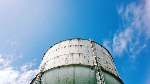 Low angle view of water tower against blue sky