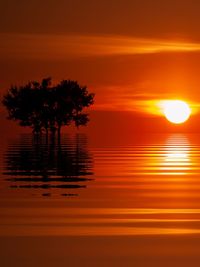 Scenic view of lake against romantic sky at sunset