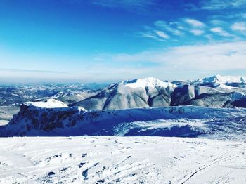 Scenic view of snowcapped mountains against sky