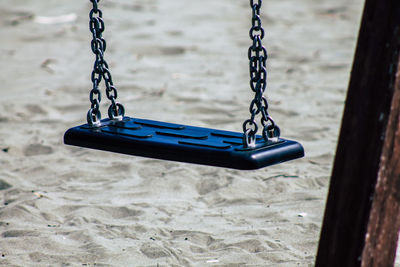 Close-up of empty swing in playground