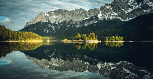 Scenic view of lake and mountains against sky