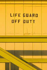 Close-up of text on yellow wall