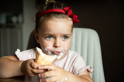 Portrait of young woman eating food