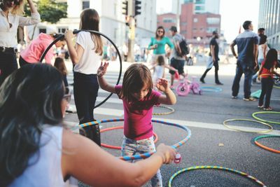 People playing on street in city