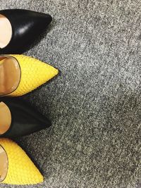 Low section of person wearing yellow shoes