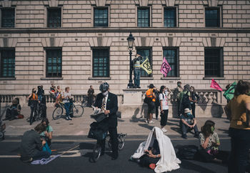 PEOPLE ON STREET AGAINST BUILDINGS