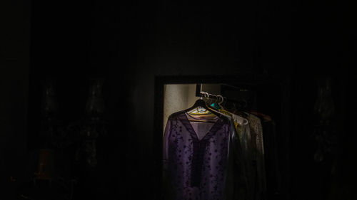 Close-up of clothes hanging on wood at home