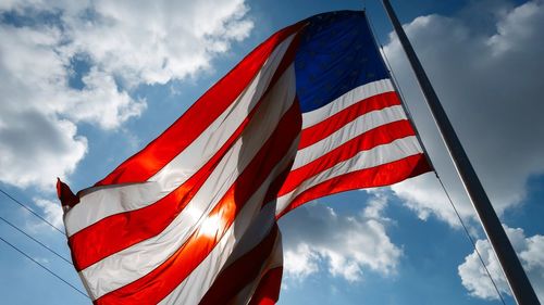 Low angle view of flag against sky