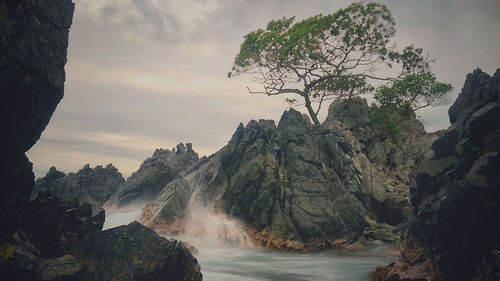 Scenic view of waterfall against sky