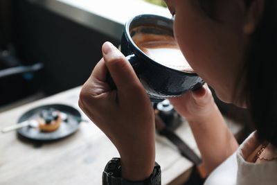 Midsection of woman holding ice cream