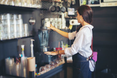 Side view of woman working in restaurant