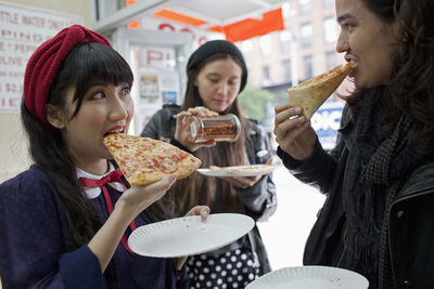 Young woman eating ice cream in restaurant