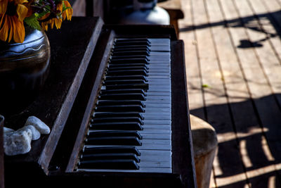 High angle view of old piano at porch