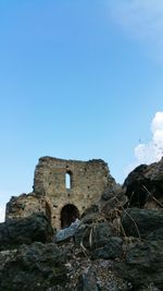 Low angle view of built structure against clear blue sky