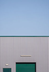 Low angle view of building against clear blue sky