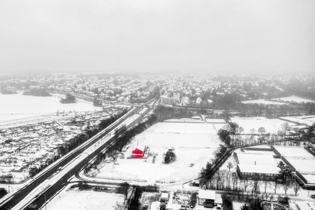 HIGH ANGLE VIEW OF SNOW COVERED CITYSCAPE