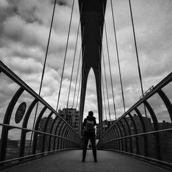 Tourists on bridge against sky