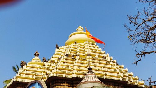 Low angle view of temple against blue sky