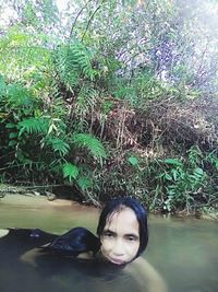 Portrait of woman against lake